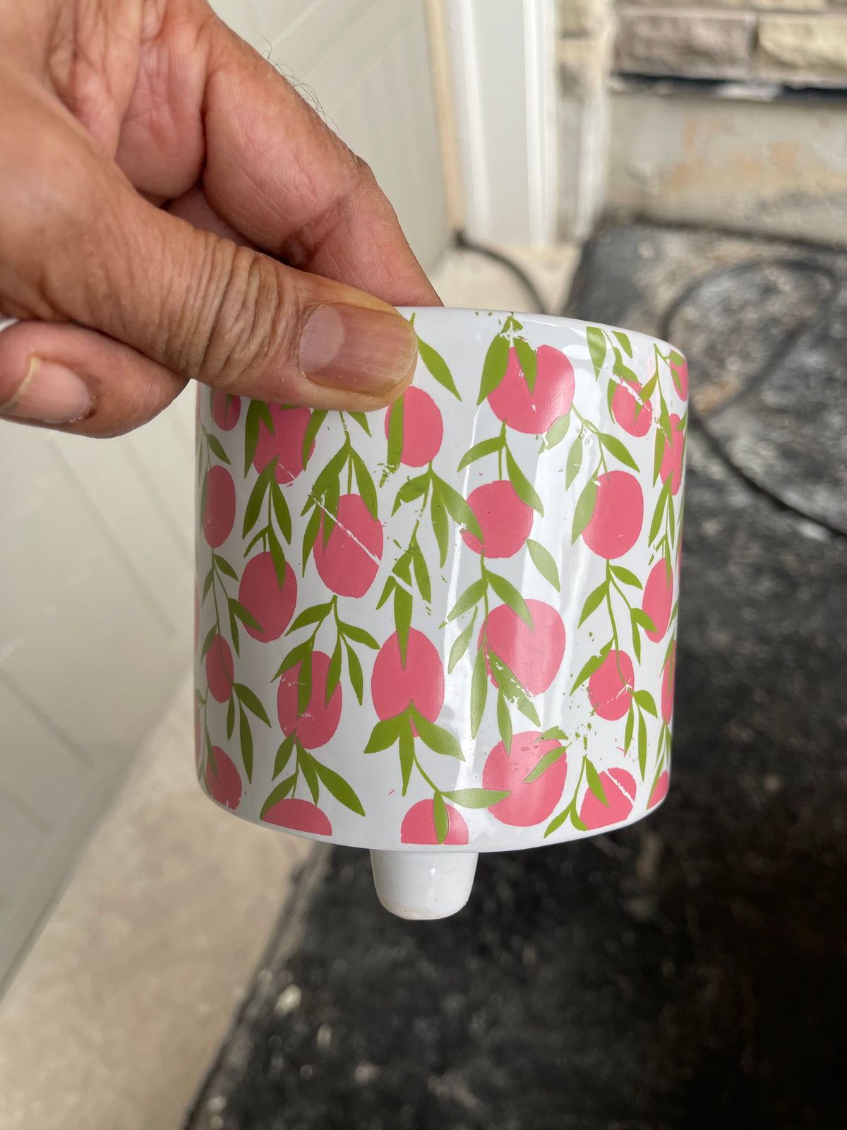 White three-footed ceramic pot with pink peach and green leaf print